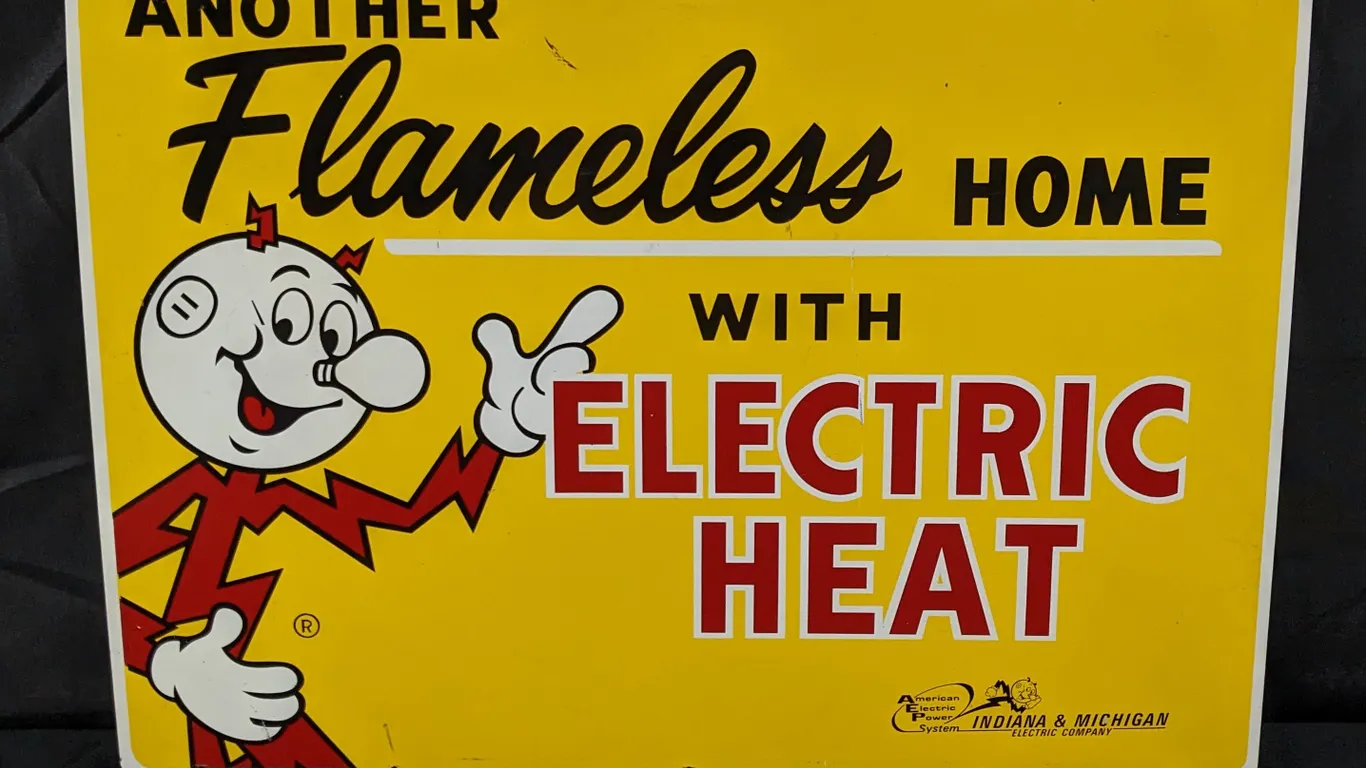 TIN SIGN REDDY KILOWATT ANOTHER FLAMELESS HOME WITH ELECTRIC HEAT INDIANA & MICHIGAN ELECTRIC COMPANY (2 SIDED)