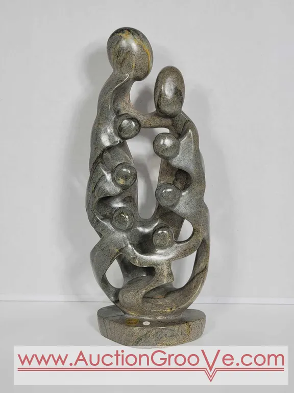 Shona Family of 8. Hand Carved in Zimbabwe. Serpentine Stone. 16.5" x 6" x 3". D2.
