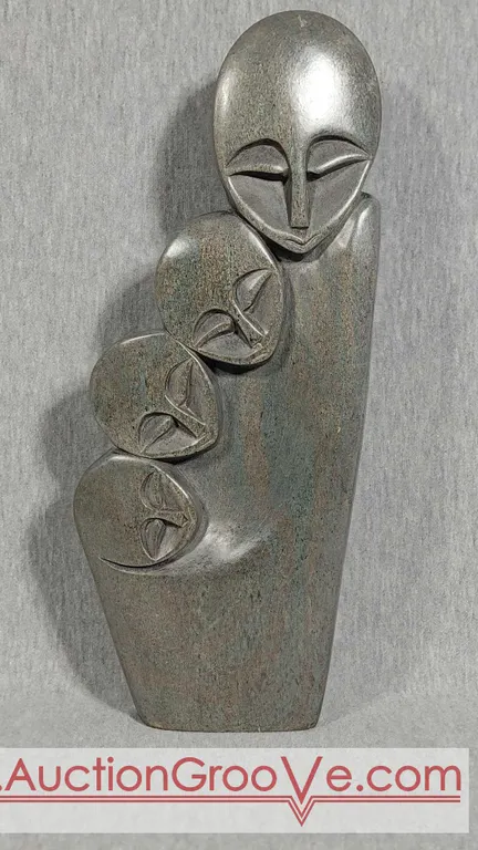 Shona Family of 4. Signed by Artist Innocent Chifutu. Hand Carved in Zimbabwe. Serpentine Stone. See photos. 12.5" x 5 x 1". D4