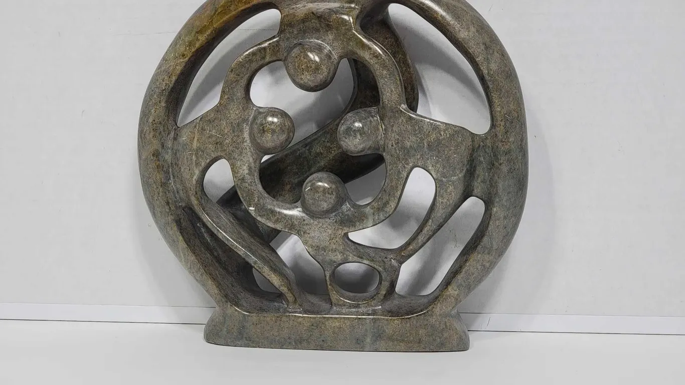 Shona Family of 4. Circle of Love. Hand Carved in Zimbabwe. Serpentine Stone. See photos. 9" x 2 x 9". D3.