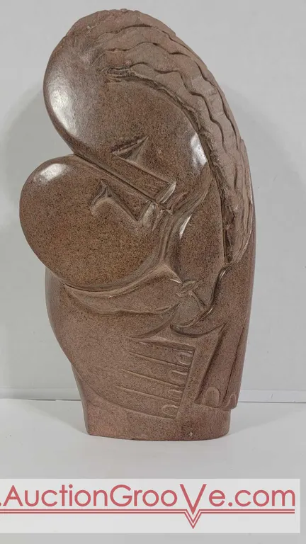 Mother with hands encircling her child. Artist signed Farai Tendai. The base shows a "flaw" on front that may have occurred naturally during o