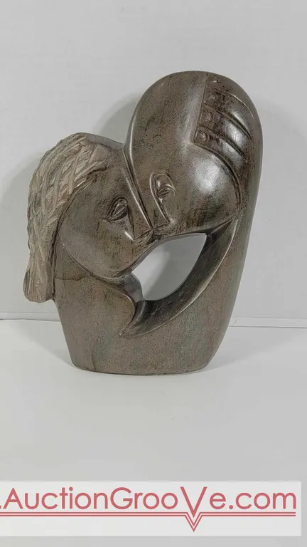 Loving Couple carved in Fruit Serpentine. Signed Farai Tendai. Est. $125 - $250. 11" x 8 x 3'. E3
