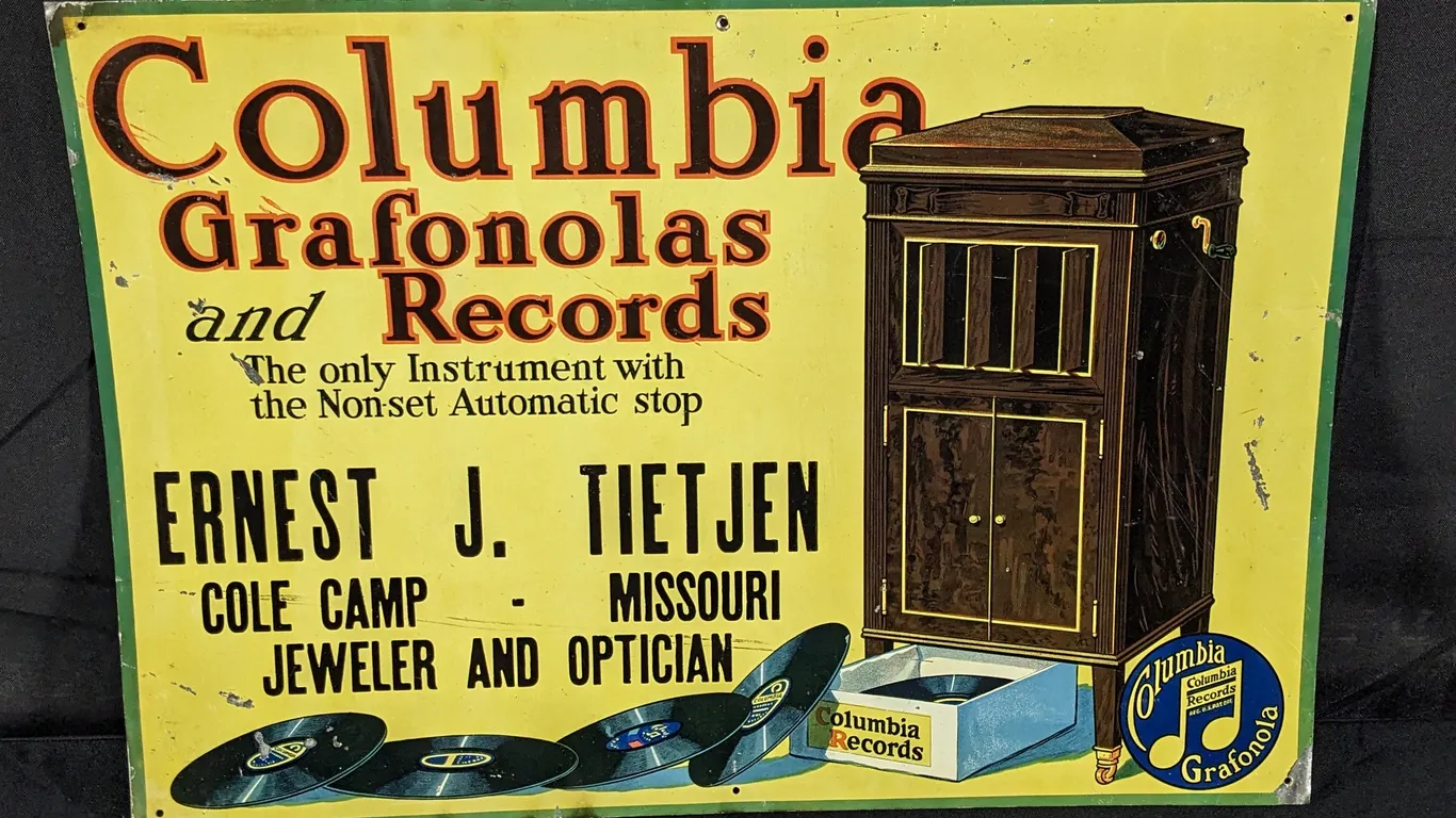TIN SIGN COLUMBIA GRAFONOLAS AND RECORDS ERNEST J. TIETJEN COLE CAMP MISSOURI JEWELER & OPTICIAN (PHONOGRAPH)