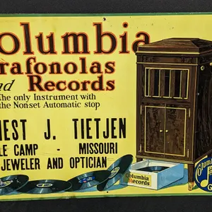 TIN SIGN COLUMBIA GRAFONOLAS AND RECORDS ERNEST J. TIETJEN COLE CAMP MISSOURI JEWELER & OPTICIAN (PHONOGRAPH)