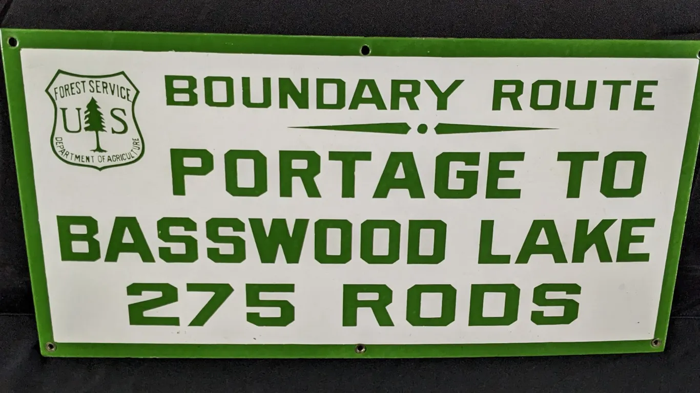 PORCELAIN SIGN US FOREST SERVICE BOUNDARY ROUTE PORTAGE TO BASSWOOD LAKE 275 RODS (ELY MINNESOTA AREA)