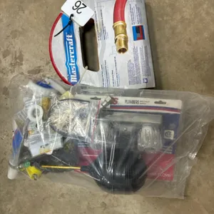 Assortment of plumbing supplies and new air hose