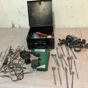 Metal box, drill - condition unknown, drill bits, hole saws, etc.