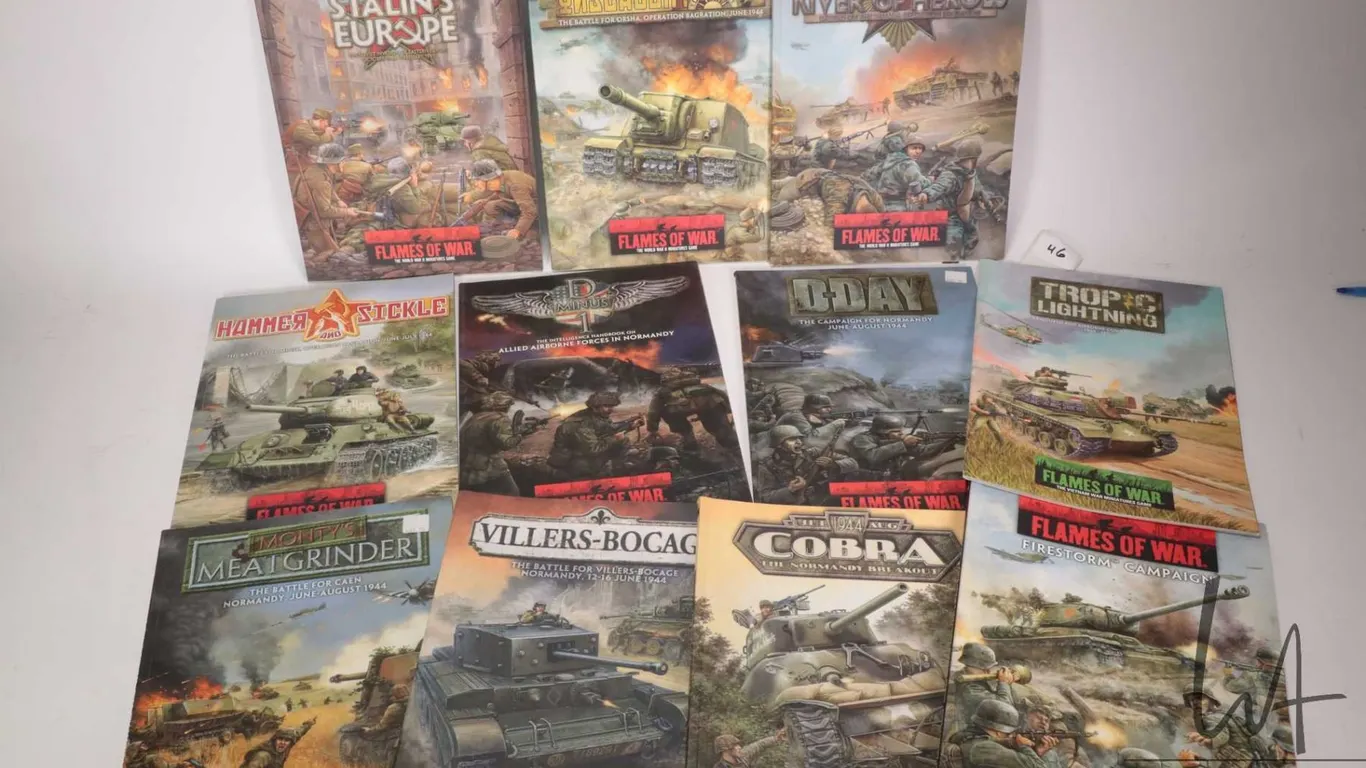 Eleven soft cover Flames of War gaming books