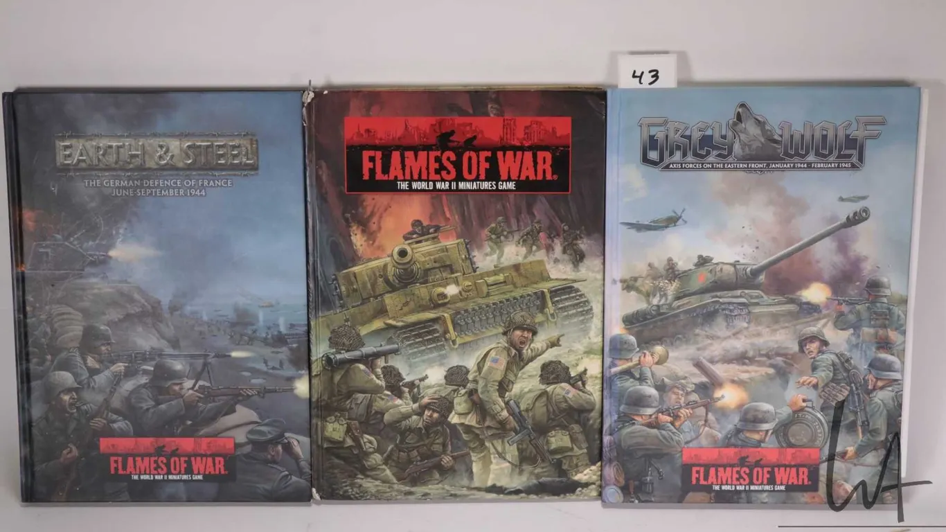 Three Flames of War hardcover gaming books including "Grey Wolf", "The World War II Miniatures Game"