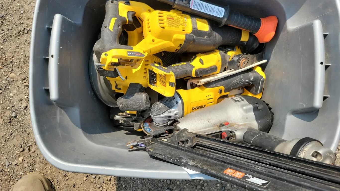 Bin full of Dewalt tools and nail gun