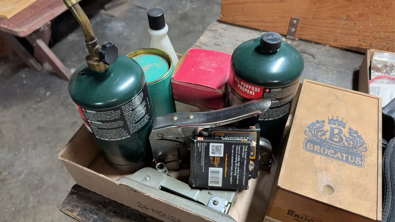 Assorted Workshop Lot Featuring Coleman Propane Cylinders Staplers Hardware Bolts