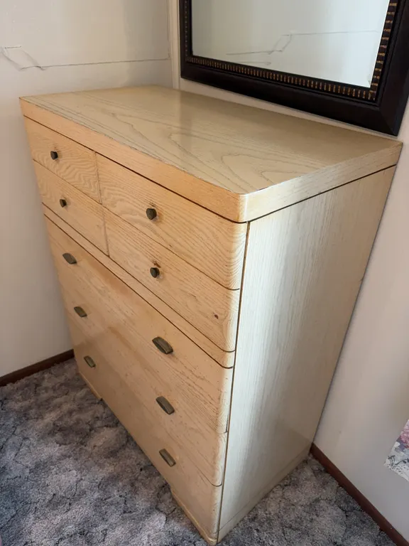 Blonde Wood Five Drawer Chest and Dark Framed Wall Mirror