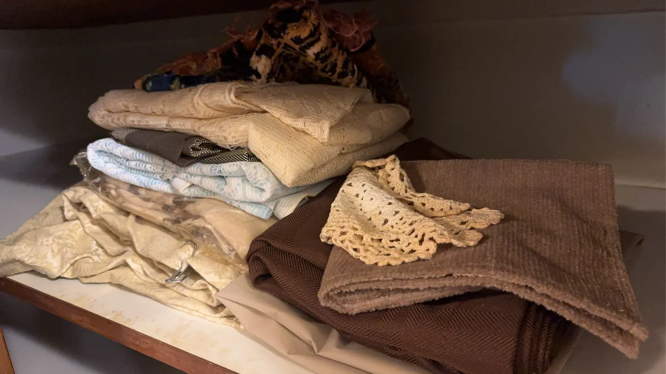 Assorted Home Textiles Including Curtains Crochet Doilies and Linens