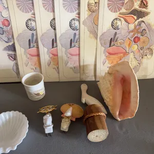 Collection of Coastal Decor Featuring Pink Conch Shell and Wooden Pelican