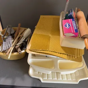 Assorted Kitchenware Lot Including Utensils Dish Mats and Rolling Pin