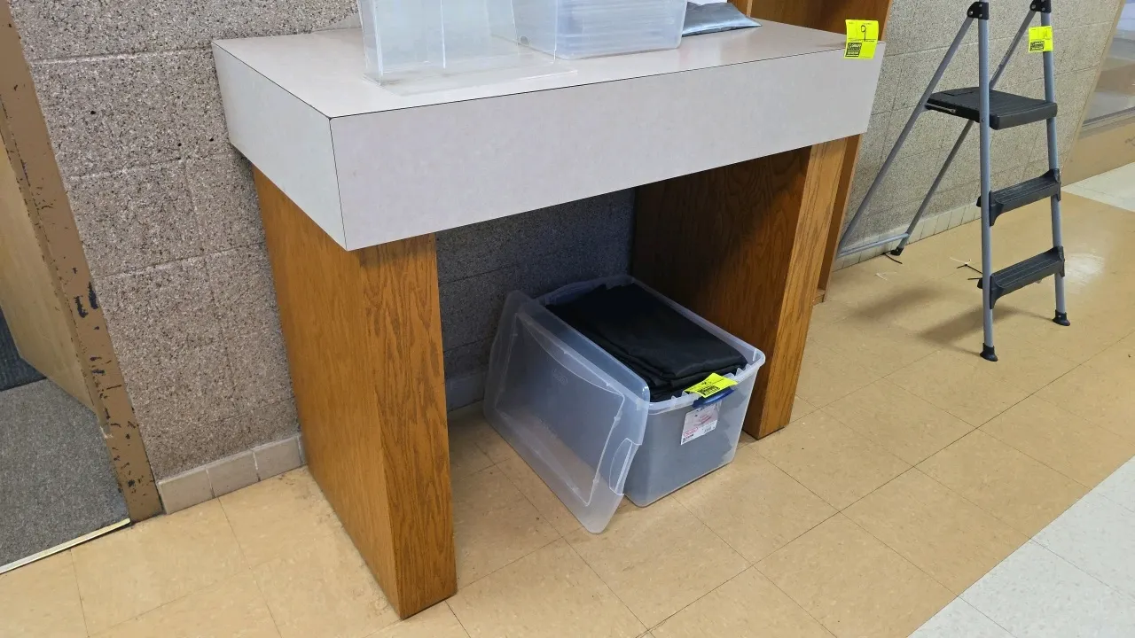 Laminate and wood stand. Features a light-colored laminate top on a sturdy wood-veneered base. Dimensions: 48" x 24" x 41". Contents not included.