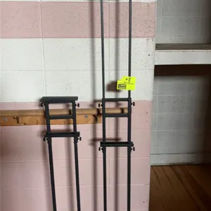 Metal sign and display stands. Includes curved-frame pedestal sign holder and adjustable telescoping graphic display stands with weighted bases. Black