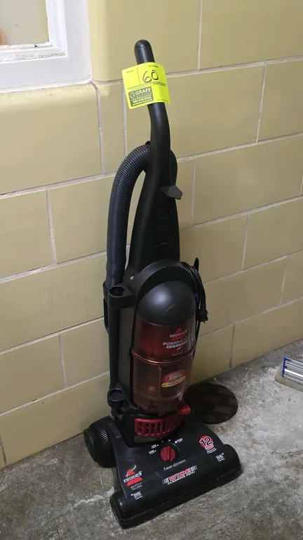 Bissell PowerForce Bagless upright vacuum. Features a 12-amp motor, 5 height adjustments, wide cleaning path, and dual edge cleaning. Equipped with a