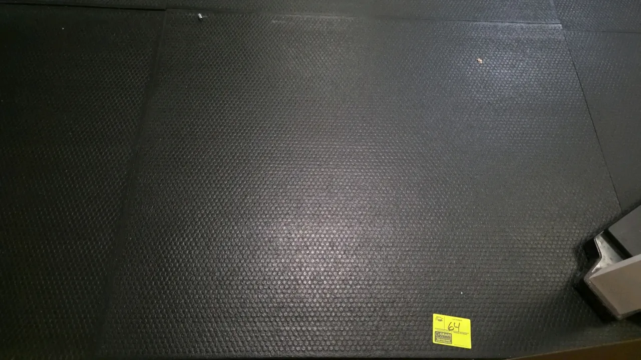 Rubber floor tiles. Features a textured, slip-resistant surface ideal for gym or utility flooring. Dimensions: 60"W x 48"D x 1/2"H each. Gym equipment