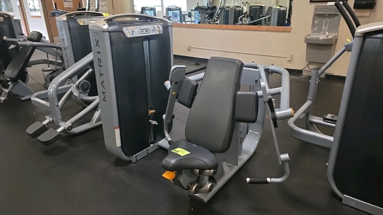 Matrix G7-S40 Biceps Curl exercise machine. Features a selectorized weight stack up to 200 lbs, adjustable seat, padded arm supports, and independent