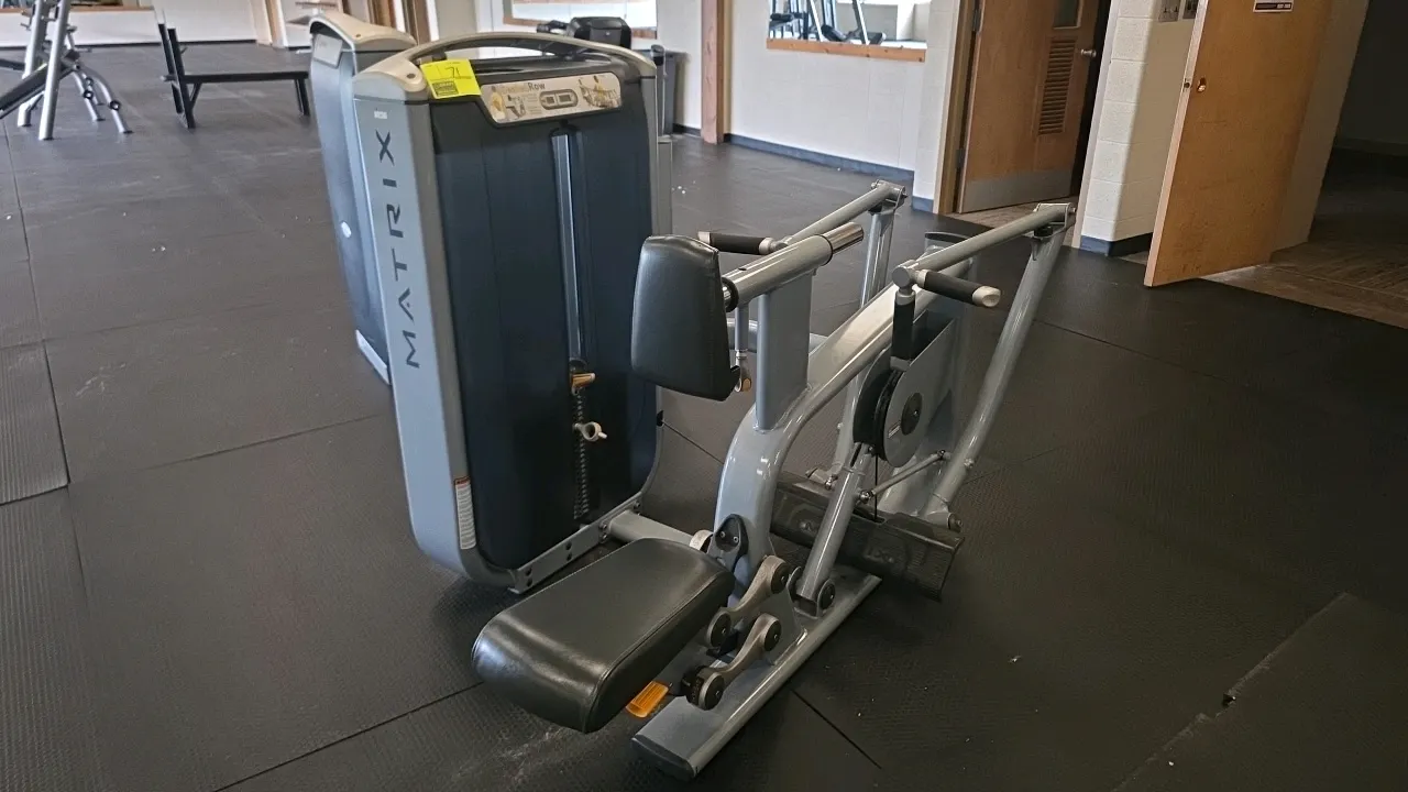 Matrix G7-S34 Seated Row exercise machine. Features an adjustable seat, adjustable chest pad, dual-position grip handles, and a selectorized weight st