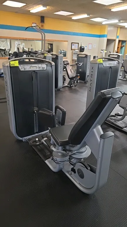 Matrix G7-S74 9 Hip Adductor exercise machine. Features a 240 lb weight stack with pin selector, adjustable knee pads, contoured upholstered seat and