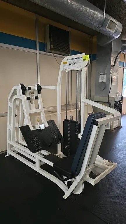 Magnum Fitness Systems Seated Leg Press exercise machine. Features a white-finished steel frame, adjustable black diamond-plate foot platform, and a p