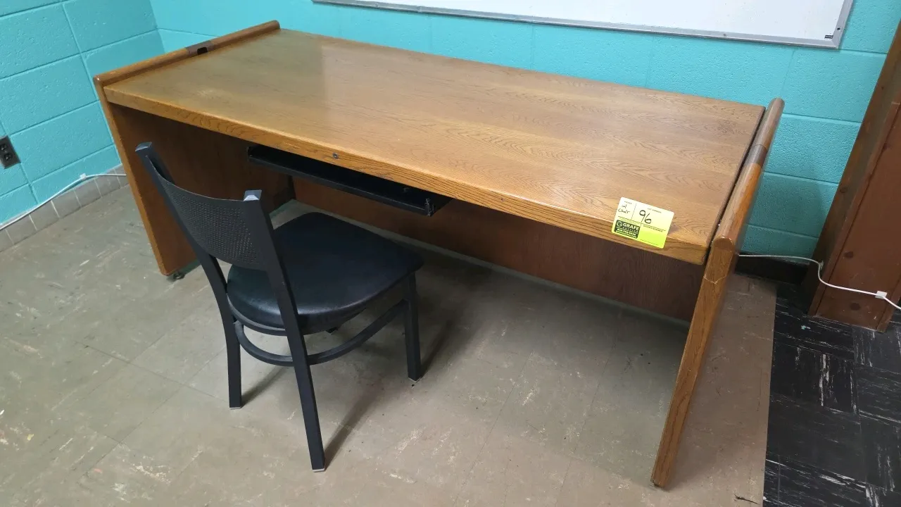 Wood desk and chair set. Desk features a single center drawer, wood construction, and raised side rails. Includes a coordinating black metal frame cha