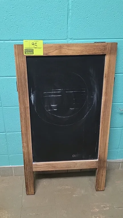 Unbranded double-sided chalkboard. Features a stained wood frame, A-frame folding design, and metal side support brackets with dual chalkboard writing