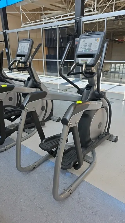 Matrix E-3x elliptical trainer. Features integrated console with multiple workout programs, target heart rate zone indicator, dual-action and stationa