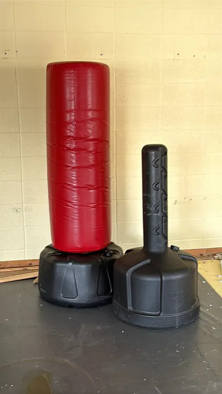 Century Wavemaster 2XL Pro freestanding kickboxing bags with stands. Features durable red vinyl covers over foam padding with low-profile black plasti