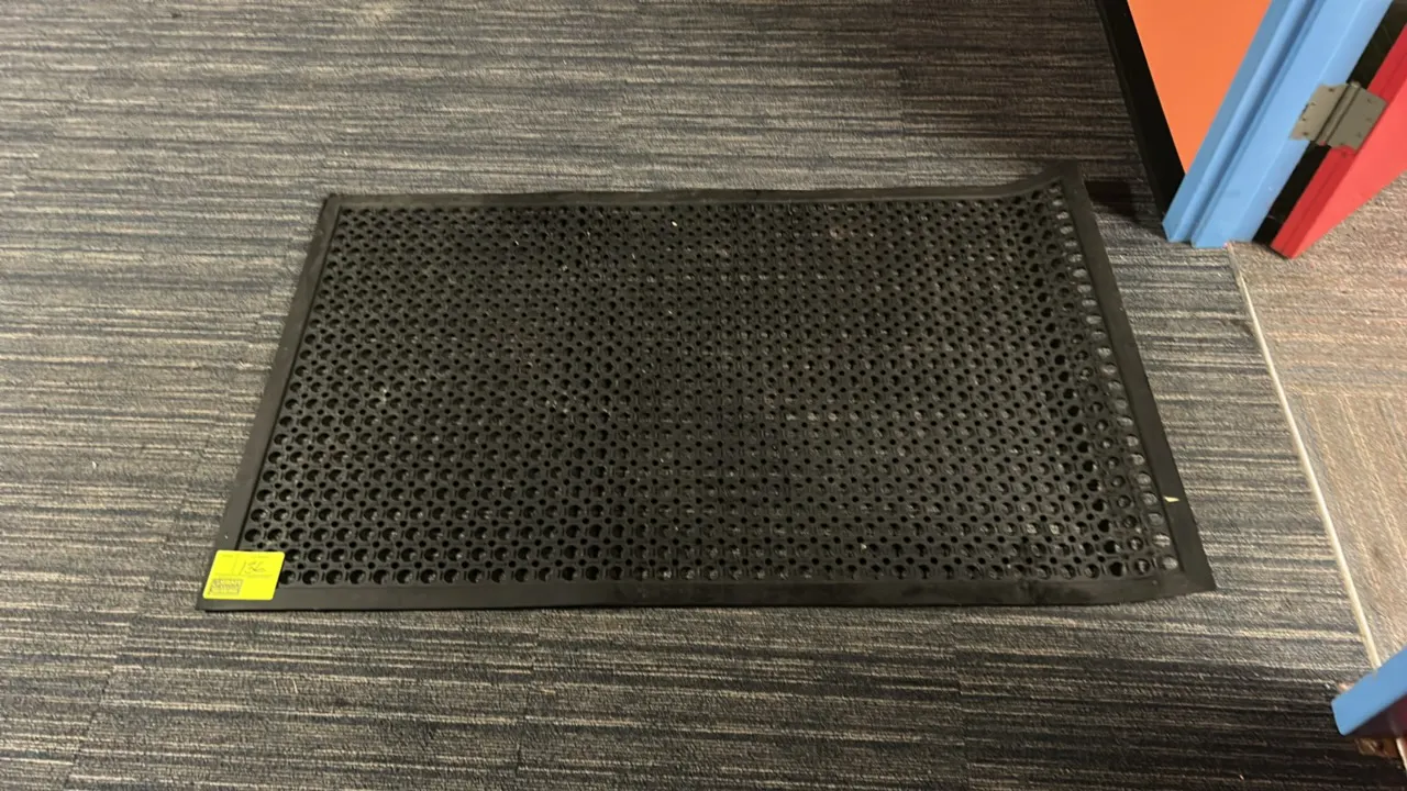 Poly floor mat. Features a black perforated design for drainage and slip resistance. 5'L.