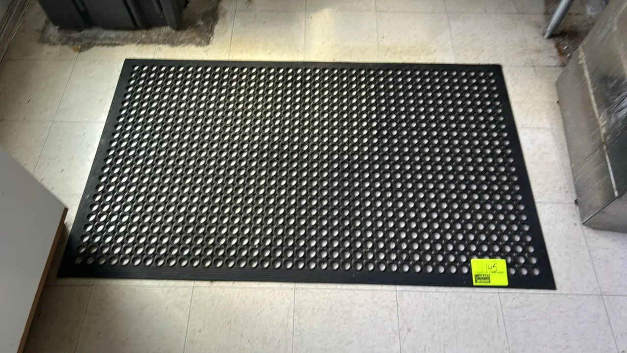 Unbranded poly floor mat. Features a black perforated anti-fatigue drainage design. 5'L.