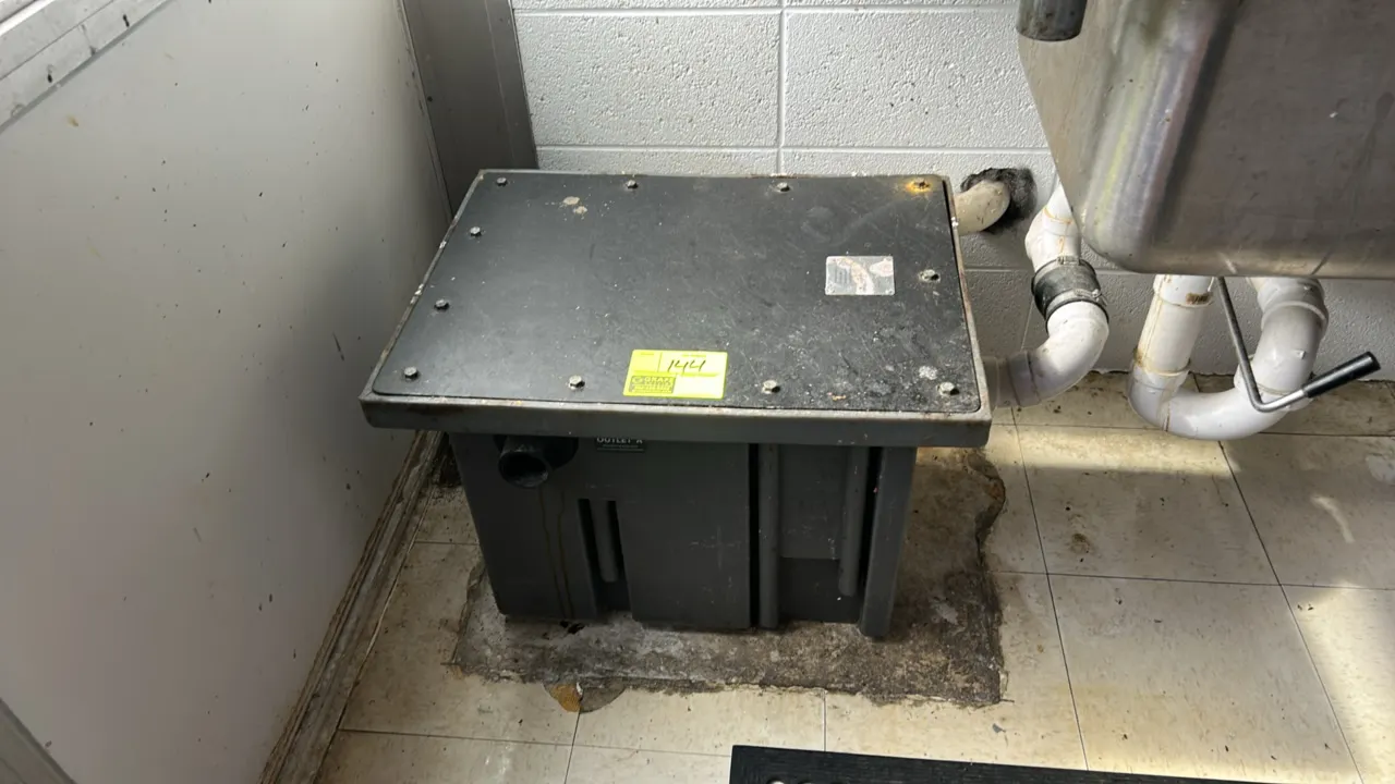 Schier grease interceptor. Features a durable polyethylene body with a bolted top-access cover. Designed for under-sink grease, oil, and sediment sepa