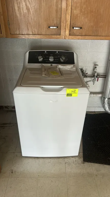 GE top-load washing machine. Features Commercial Quality design, a stainless steel wash basket, traditional agitator, and rotary control dials. Includ