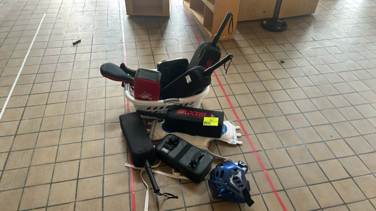 Assorted martial arts training gear. Includes Century Blocker padded blocking sticks, hand-held striking shields, Kick Partner target paddles, a chest