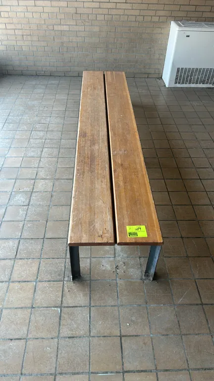 Wooden benches. Features two-slat wood seats. Mounted on metal legs with center supports. 8'L.