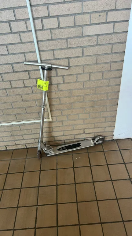 Razor A folding kick scooter. Features aluminum construction, adjustable-height handlebars, and a rear fender brake. Designed to fold for convenient s