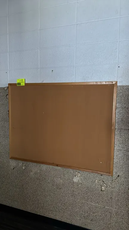 Unbranded cork board. Features a wooden frame and cork tack surface. Designed for wall mounting. Dimensions: 4'W x 3'H.