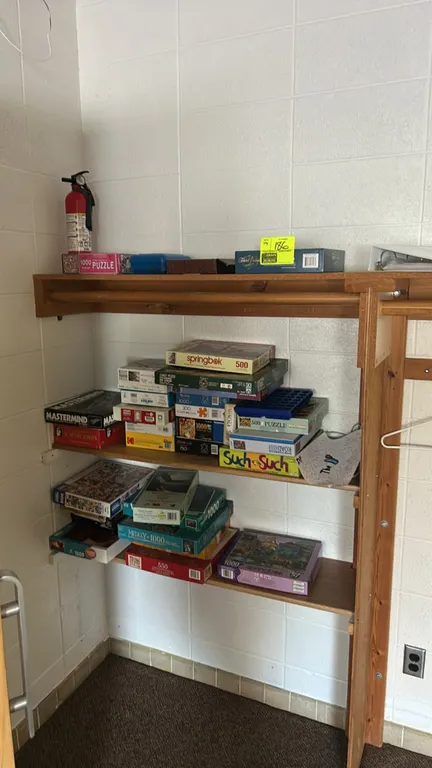 Assorted board games and jigsaw puzzles. Includes titles such as Mastermind, Scattergories, Such & Such, and Trivial Pursuit, along with various jigsa