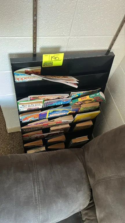 Metal magazine organizer. Features a multi-tiered design with slots for literature display. Black finished metal construction. Contents not included.