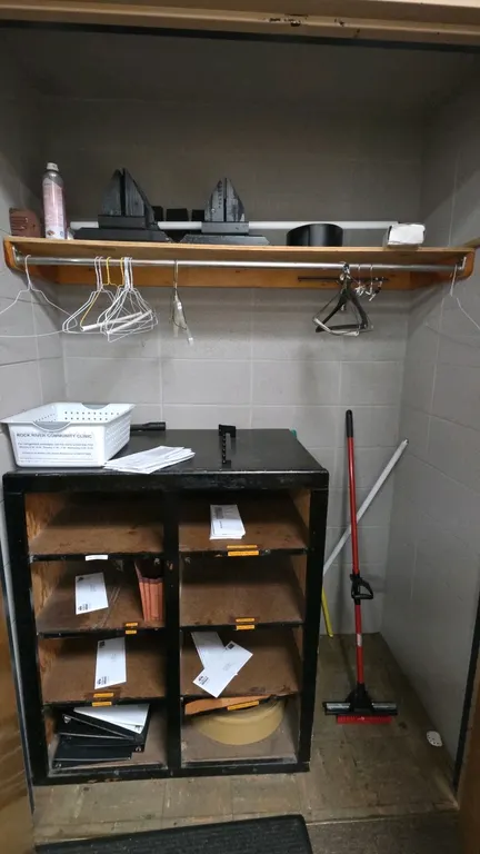 Closet contents package lot. Includes a two-column multi-tier wood organizer cabinet, wall-mounted wood shelf with metal hanging rod, assorted plastic