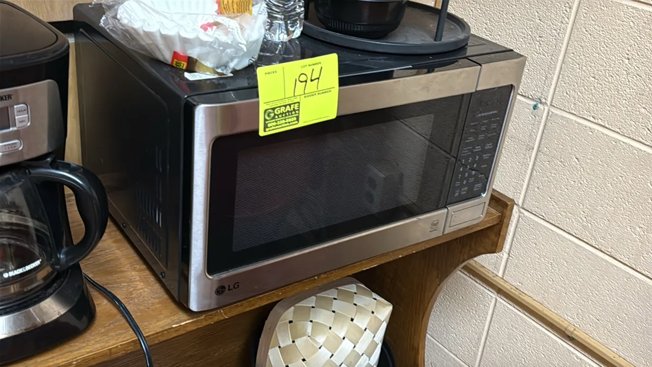 LG countertop microwave oven. Features a stainless steel and black exterior, digital keypad control panel, push-button door release, and an interior g