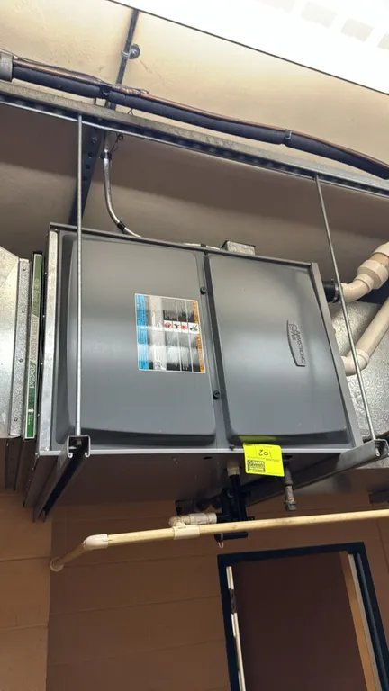 Armstrong Air gas furnace. Features a horizontal configuration and side-loading filter slot currently fitted with a 20" x 25" x 1" filter. Suspended f
