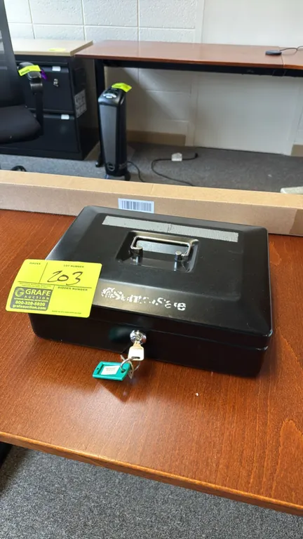 SentrySafe metal cash box. Features a folding top carry handle, key lock with keys, and a removable multi-compartment plastic interior tray. Note: Tap