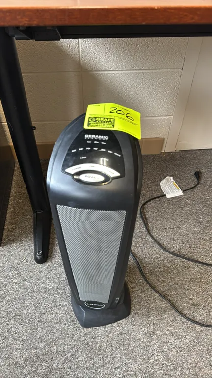 Lasko ceramic tower space heater. Features top digital control panel, adjustable temperature settings, timer, and oscillation. Built-in rear carry han