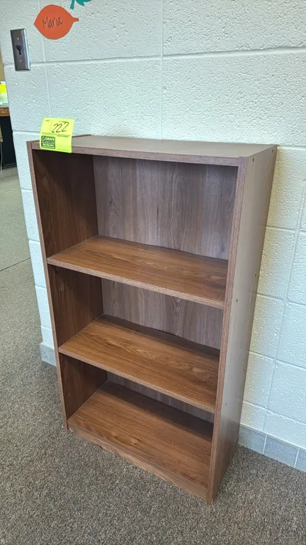 Laminate bookcase. Features a woodgrain finish and two adjustable shelves. Dimensions: 23"W x 10"D x 40"H.
