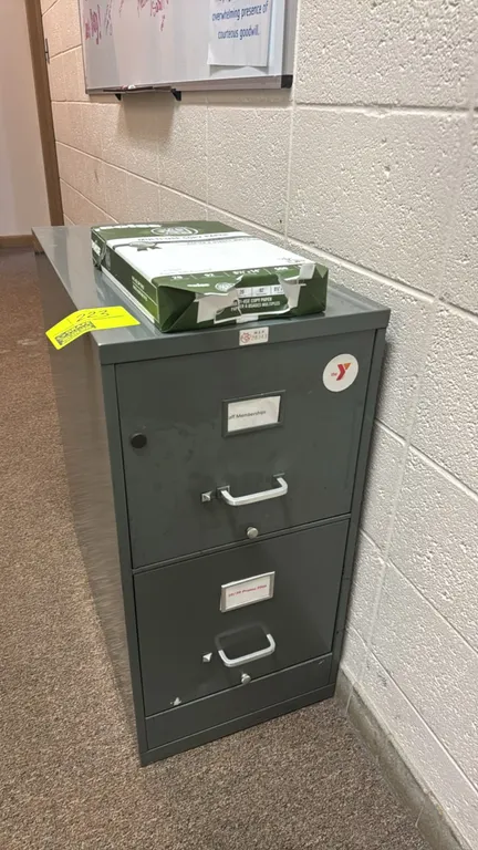 Metal 2-drawer vertical file cabinet. Features silver-tone pull handles, integrated label holders, and drawer follower blocks. Color: Gray. Paper on t