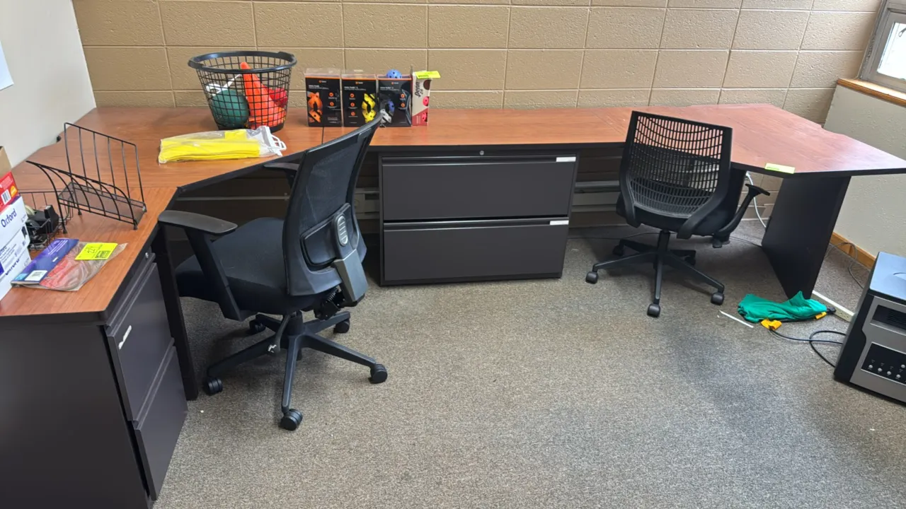 Metal and laminate office desk suite. Modular configuration features a woodgrain laminate top desk, a 2-drawer pedestal cabinet, a 2-drawer lateral fi