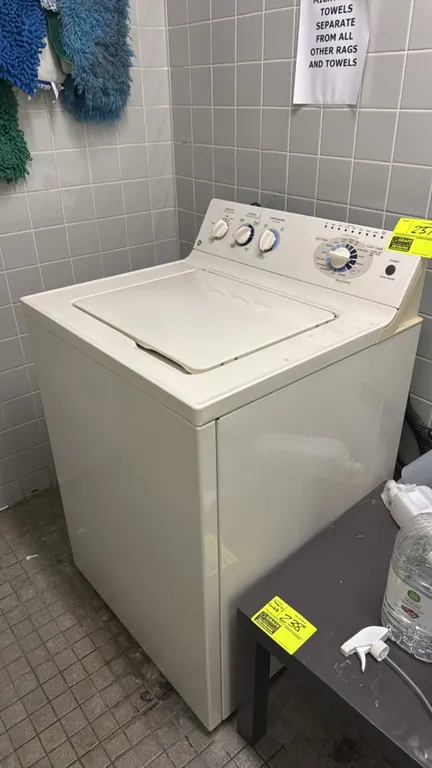 GE top-loading washing machine. Features Super Capacity Plus wash tub with central agitator, 4 wash and spin speed selections, and 15 clothes care cyc